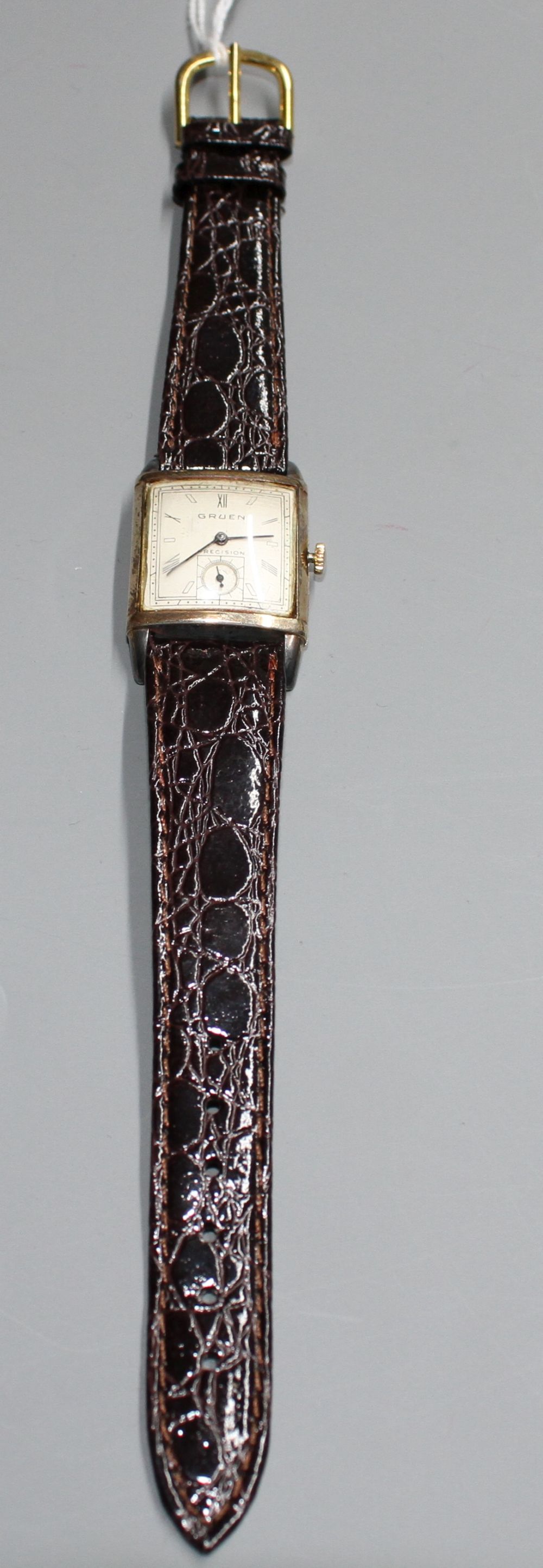 A gentlemans 1930s? 10k gold filled Gruen Precision manual wind wrist watch, with rectangular Roman and baton dial